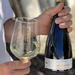 Person holding a bottle and glass of azabache tempranillo rioja blanco
