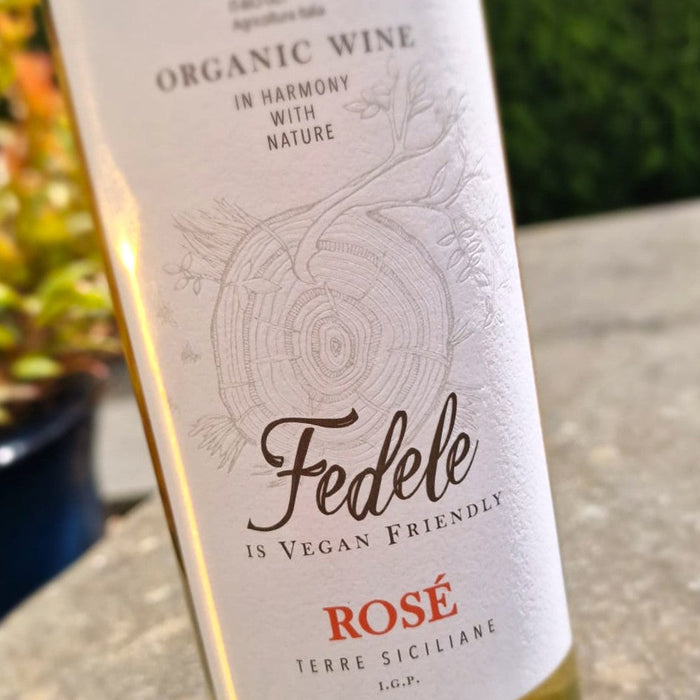 Bottle of Fedele Rosé wine with a label indicating organic and vegan-friendly qualities.